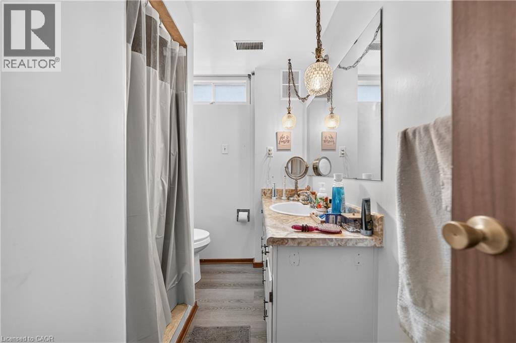 Bathroom vanity with a light-toned countertop, integrated sink, and white cabinetry - 111 Kimberly Crescent, Kitchener, ON - Indoor Photo Showing Bathroom