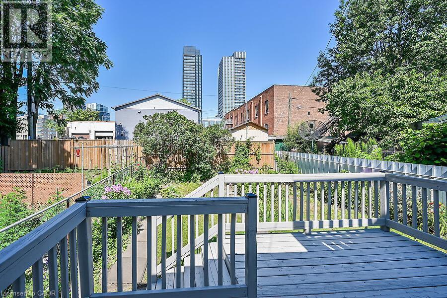Spacious outdoor deck with painted wood railing overlooking a verdant yard - 103 Mary Street, Hamilton, ON - Outdoor