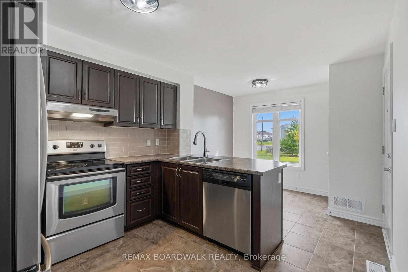 Kitchen with breakfast nook... - 2330 Esprit Drive, Ottawa, ON - Indoor Photo Showing Kitchen With Stainless Steel Kitchen With Double Sink