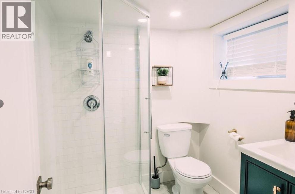 Glass-enclosed shower featuring white subway tile, a chrome showerhead, and a matching chrome control handle - 47 Eagle Avenue, Brantford, ON - Indoor Photo Showing Bathroom