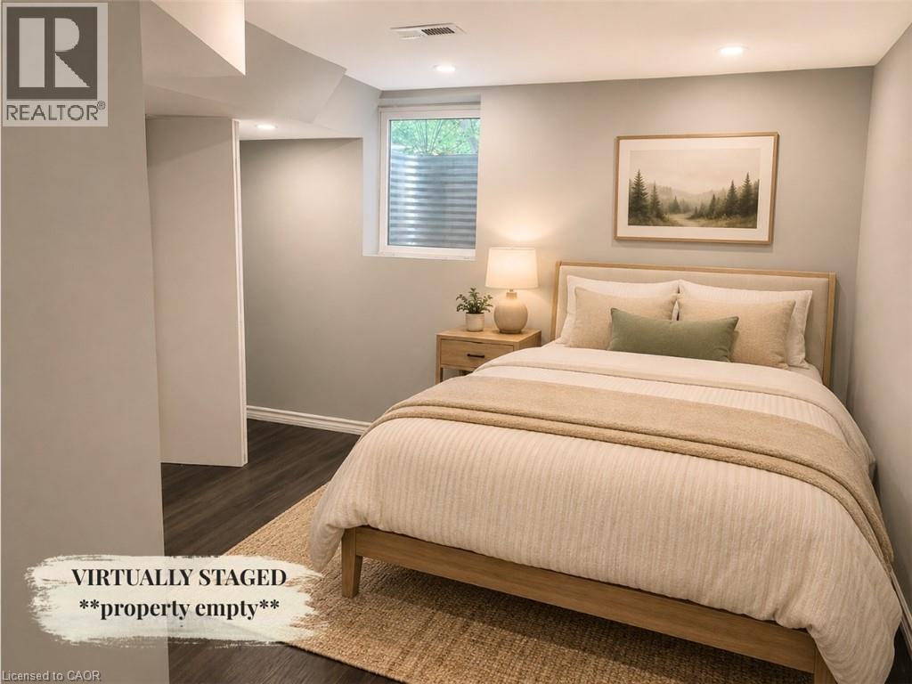 Room featuring recessed lighting, a window with horizontal blinds, wood-finish flooring, and light-toned walls - 90 Arlington Boulevard Unit# Bsmt, Kitchener, ON - Indoor Photo Showing Bedroom