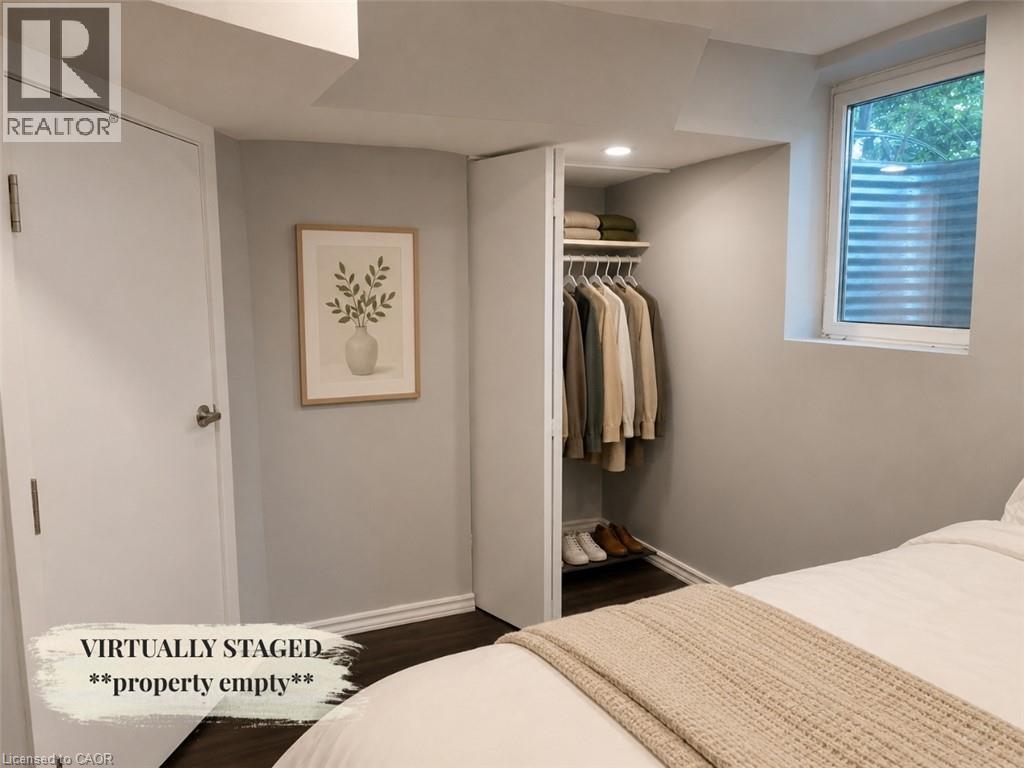 Recessed lighting, wood-finish flooring, and white trim work - 90 Arlington Boulevard Unit# Bsmt, Kitchener, ON - Indoor Photo Showing Bedroom