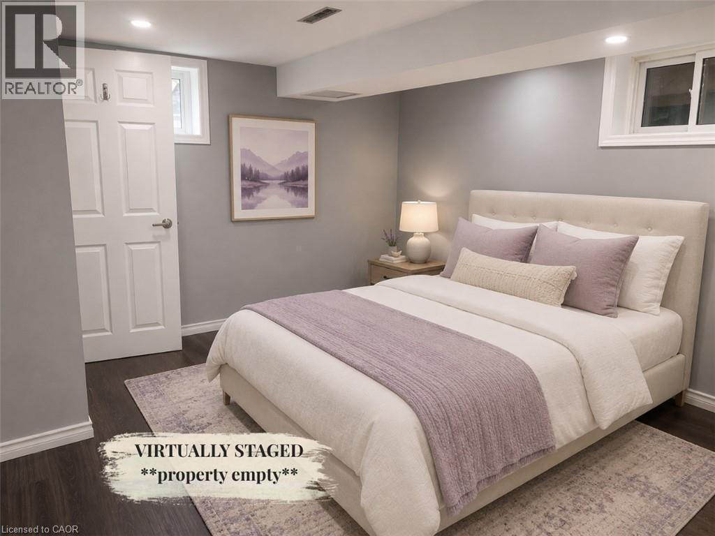 Room featuring dark wood-finish flooring, light gray painted walls, and white trim - 90 Arlington Boulevard Unit# Bsmt, Kitchener, ON - Indoor Photo Showing Bedroom