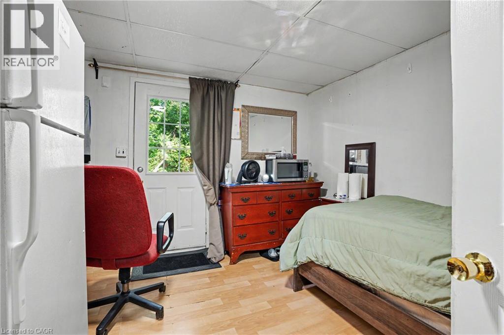 Room with wood-finish flooring, white walls, a white ceiling, and a door with an exterior window - 47 Bowman Street, Hamilton, ON - Indoor Photo Showing Bedroom