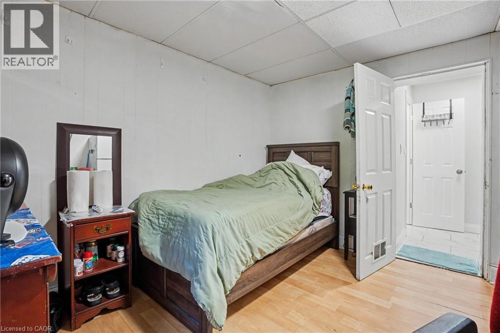 Room with light wood-finish flooring and white paneled walls - 47 Bowman Street, Hamilton, ON - Indoor Photo Showing Bedroom