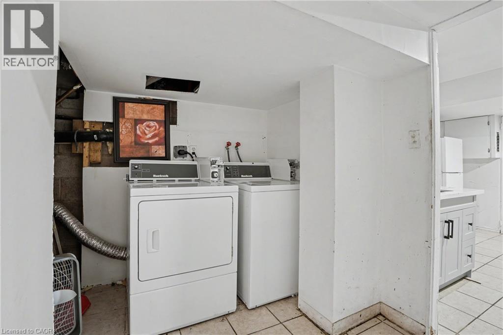 Dedicated laundry area featuring white appliances and tiled flooring - 47 Bowman Street, Hamilton, ON - Indoor Photo Showing Laundry Room