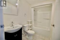 Contemporary bathroom with a black vanity, integrated white sink, and chrome faucet -