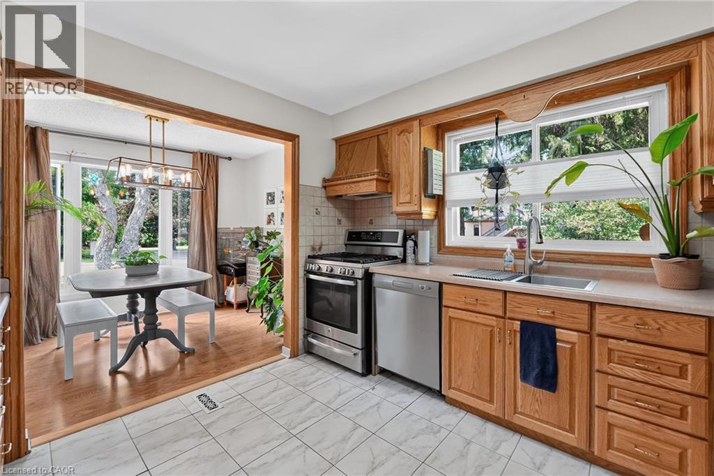 Kitchen featuring wood cabinetry, stainless steel appliances, and a double basin sink - 3 Orchard Parkway, Grimsby, ON - Indoor Photo Showing Kitchen With Double Sink