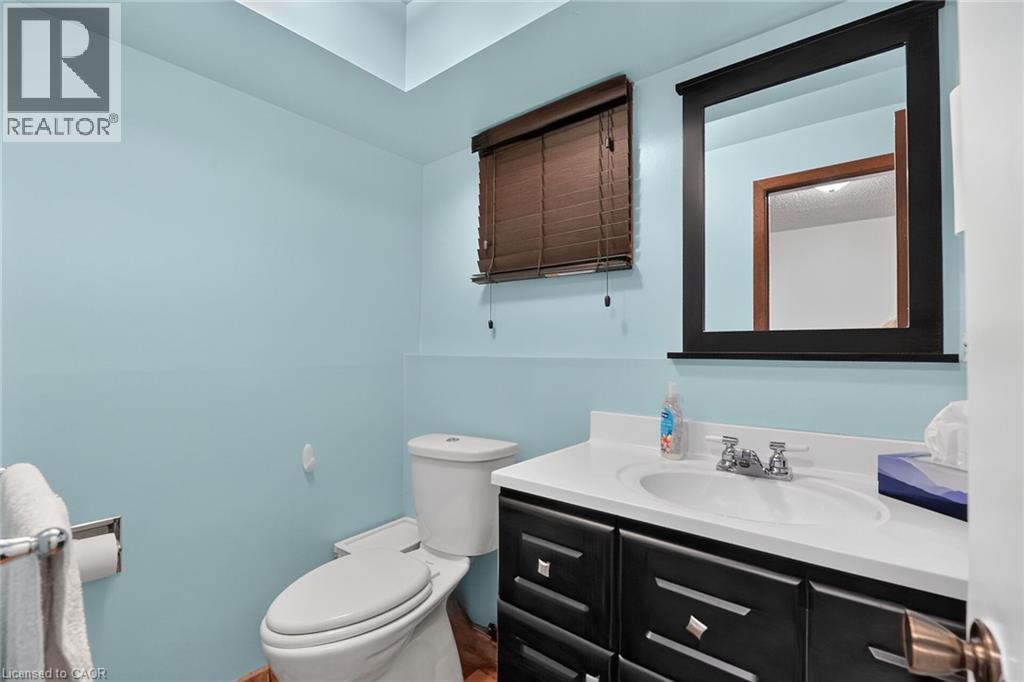 Bathroom featuring a dark wood-finish vanity with a white countertop and integrated sink - 3 Orchard Parkway, Grimsby, ON - Indoor Photo Showing Bathroom