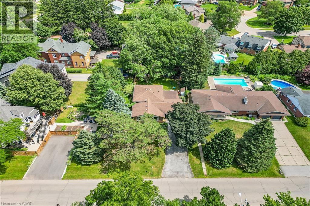 Aerial perspective showcasing a property with a brown shingled roof, a paved driveway, and mature landscaping - 3 Orchard Parkway, Grimsby, ON - Outdoor With View