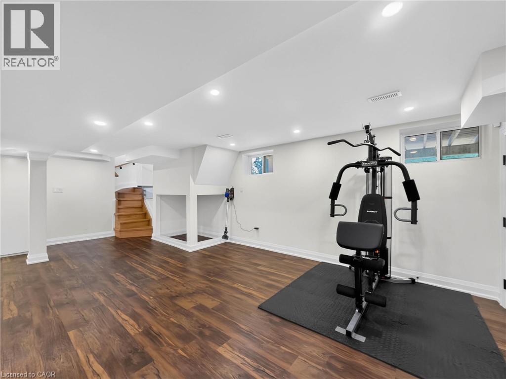 Finished basement space featuring recessed lighting and wood-finish flooring - 5178 Hunter Drive, Burlington, ON - Indoor