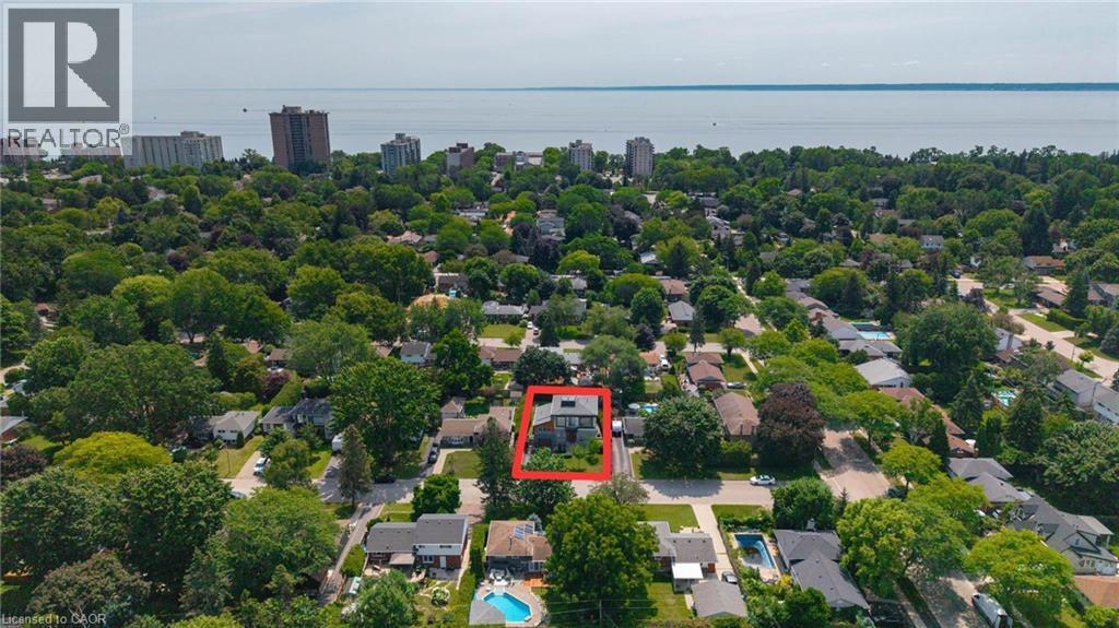 Aerial perspective showcasing the property's position within a verdant neighborhood - 5178 Hunter Drive, Burlington, ON - Outdoor With Body Of Water With View