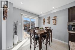 Dining area with light gray walls and recessed lighting - 