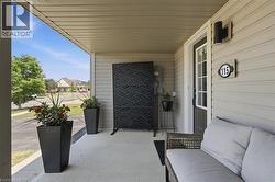 Covered front porch with light-toned siding - 