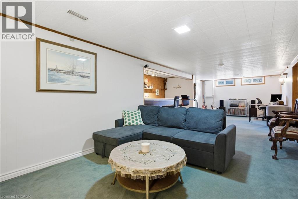 Expansive recreation room featuring green carpeting and white walls - 11 Summit Crescent, Guelph, ON - Indoor Photo Showing Living Room