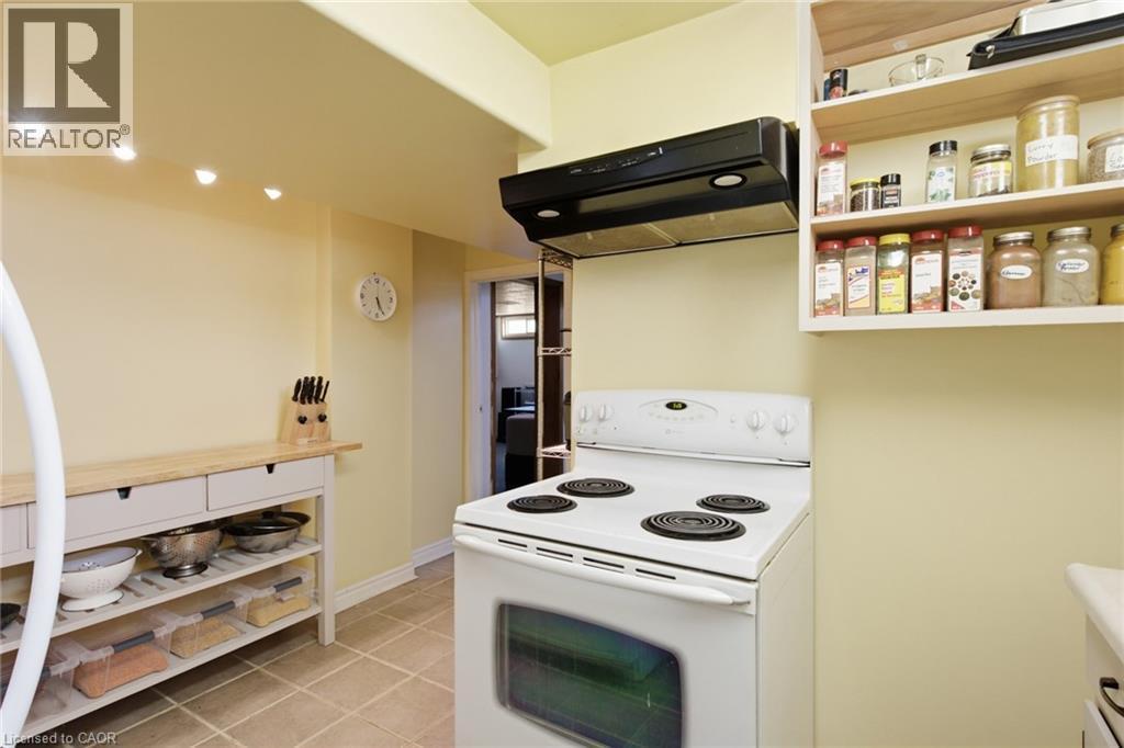 Kitchen featuring a white electric range, black range hood, and open shelving - 11 Summit Crescent, Guelph, ON - Indoor Photo Showing Kitchen