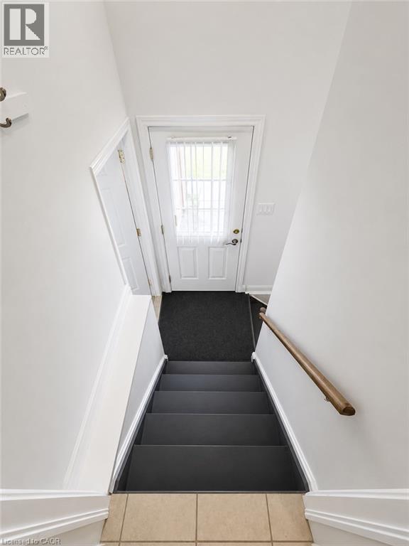 Entrance to lower level w/separate entrance & garage access - 7 Spitfire Drive, Mount Hope, ON - Indoor Photo Showing Other Room