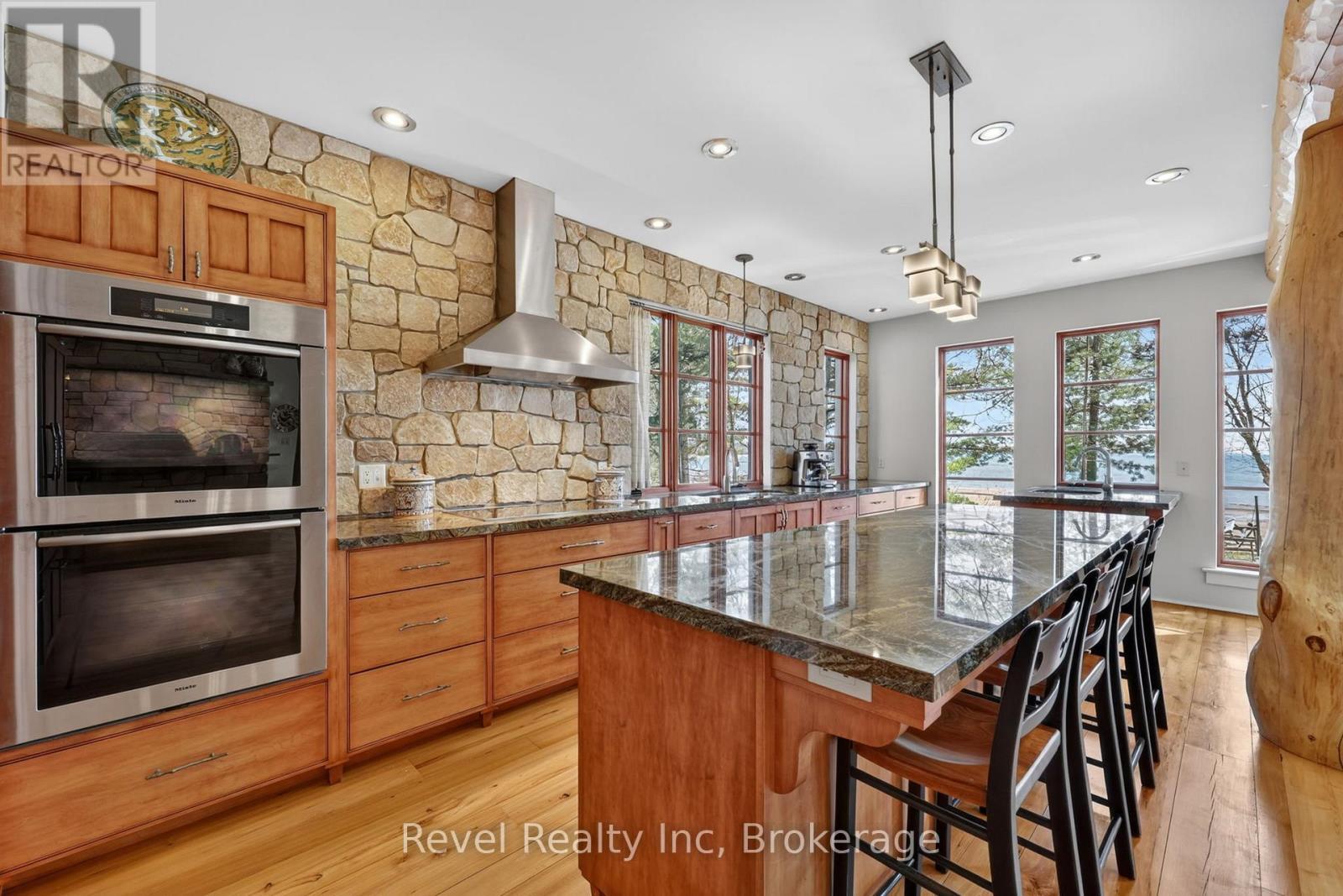 Miele double oven and beautiful Stone wall - 12 Walker Road, Tiny, ON - Indoor Photo Showing Kitchen With Upgraded Kitchen