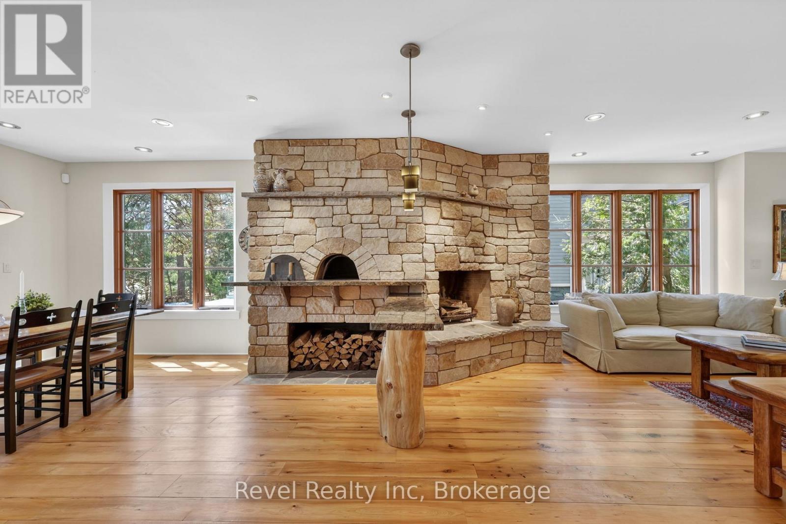 Rumford Fireplace & adjacent pizza oven - 12 Walker Road, Tiny, ON - Indoor Photo Showing Living Room With Fireplace