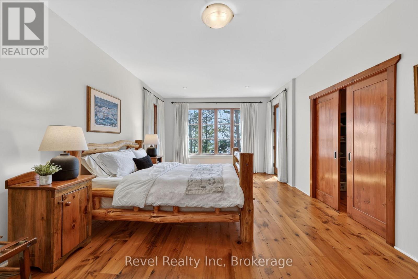Master retreat w reclaimed pine flooring - 12 Walker Road, Tiny, ON - Indoor Photo Showing Bedroom