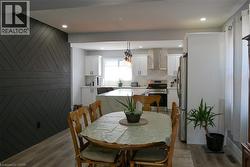 Open-concept dining area featuring a distinctive dark accent wall with a chevron pattern - 