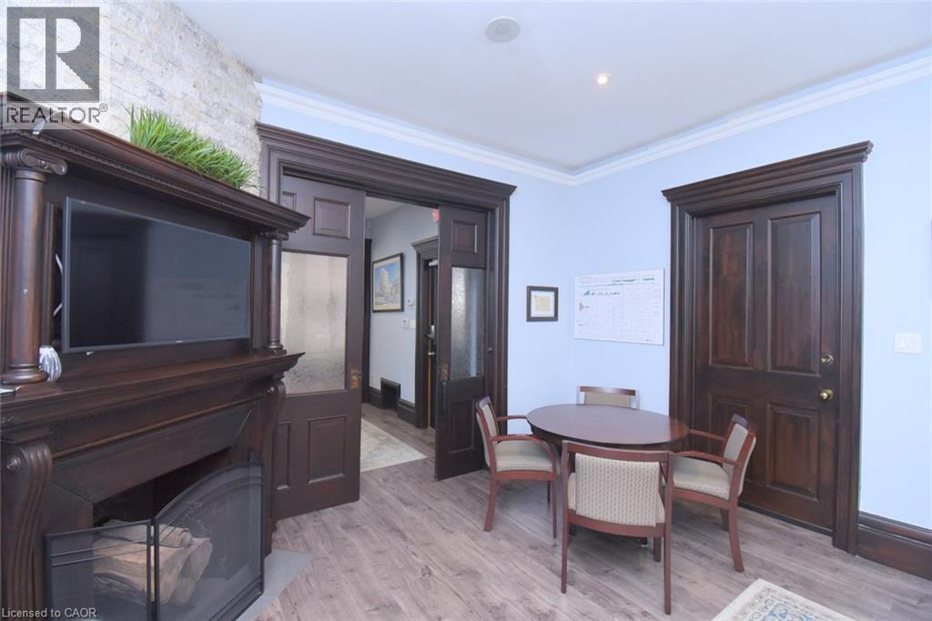 Wood-finish flooring complementing dark wood trim and doors - 108 George Street, Hamilton, ON