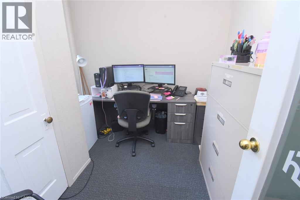 Dedicated room featuring textured wall finishes and dark gray carpet flooring - 108 George Street, Hamilton, ON