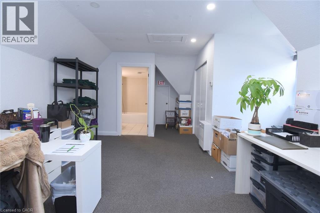 Carpeted room with sloped ceilings and recessed lighting - 108 George Street, Hamilton, ON