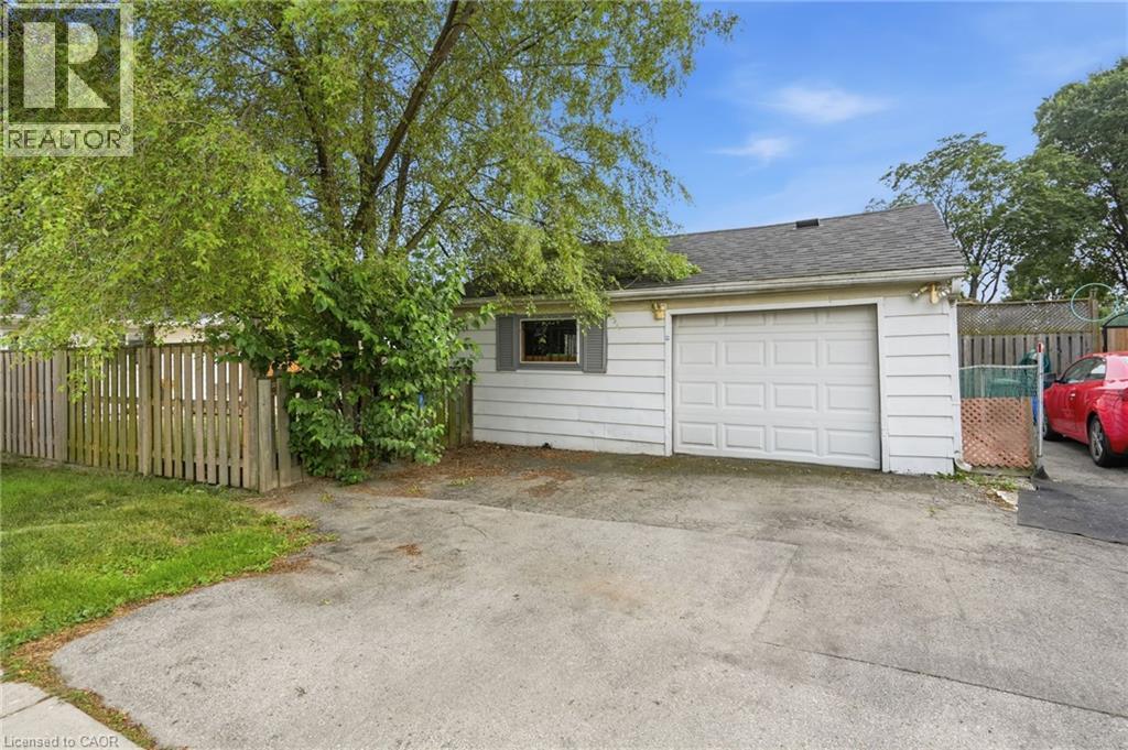 Detached garage with a paneled overhead door, white siding exterior, and a shingled roof - 432 Upper Sherman Avenue, Hamilton, ON - Outdoor