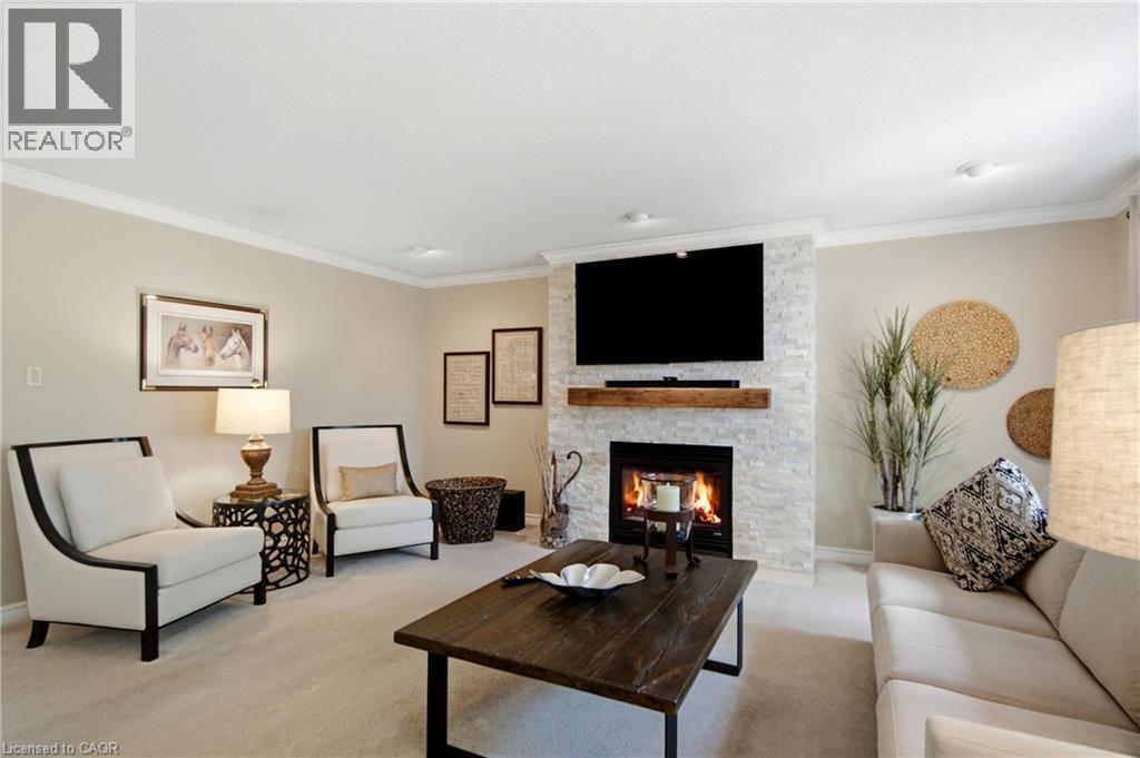 Stone-clad fireplace with a wood mantel - 1090 Crofton Way, Burlington, ON - Indoor Photo Showing Living Room With Fireplace
