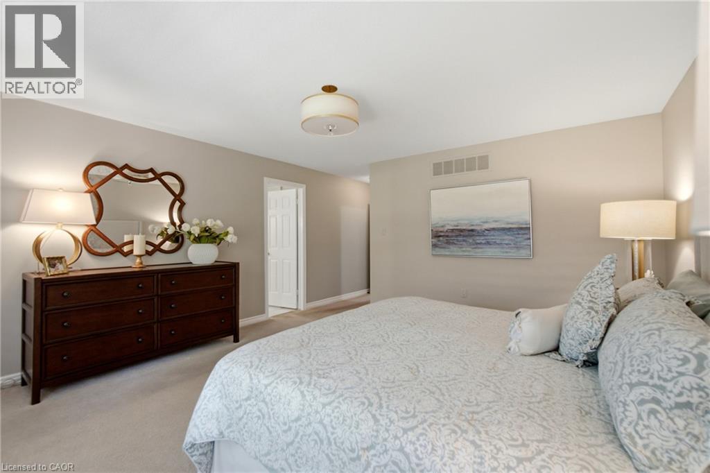 Plush carpeting and neutral wall tones define this expansive interior - 1090 Crofton Way, Burlington, ON - Indoor Photo Showing Bedroom