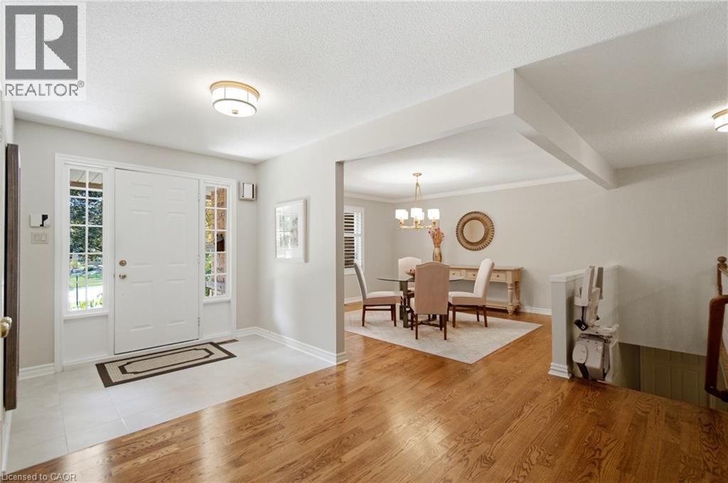 Inviting entryway with a white paneled door, sidelight windows, and a tile floor - 1090 Crofton Way, Burlington, ON - Indoor