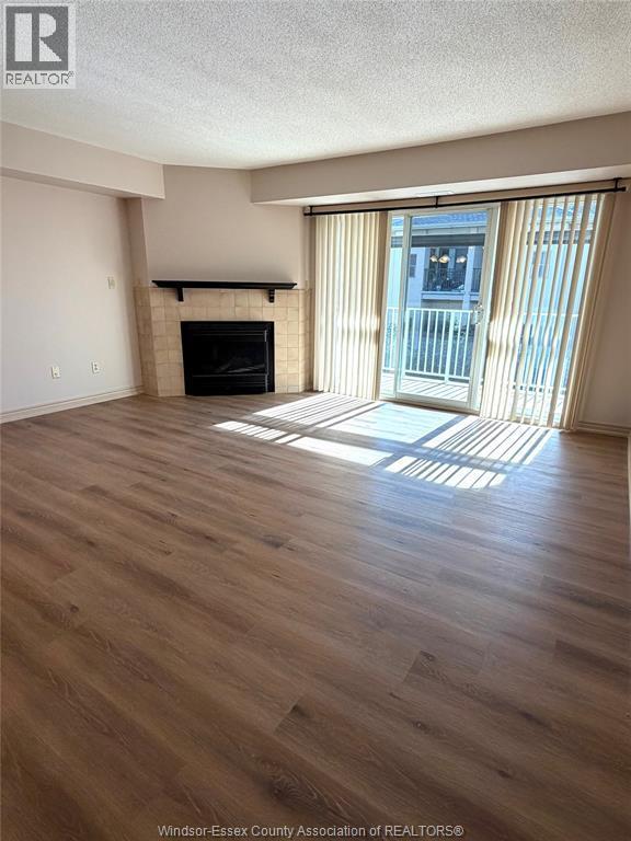 1995 Normandy Unit# 301, Lasalle, ON - Indoor Photo Showing Living Room With Fireplace
