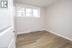 Neutral tone walls complemented by wood-finish flooring - 