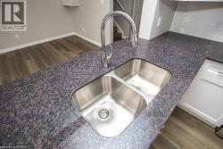 Dual basin stainless steel sink with a high-arch chrome faucet - 
