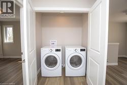 Dedicated laundry closet with full-sized appliances and bi-fold panel doors - 