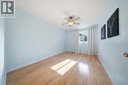Light wood-finish flooring complements soft blue walls - 