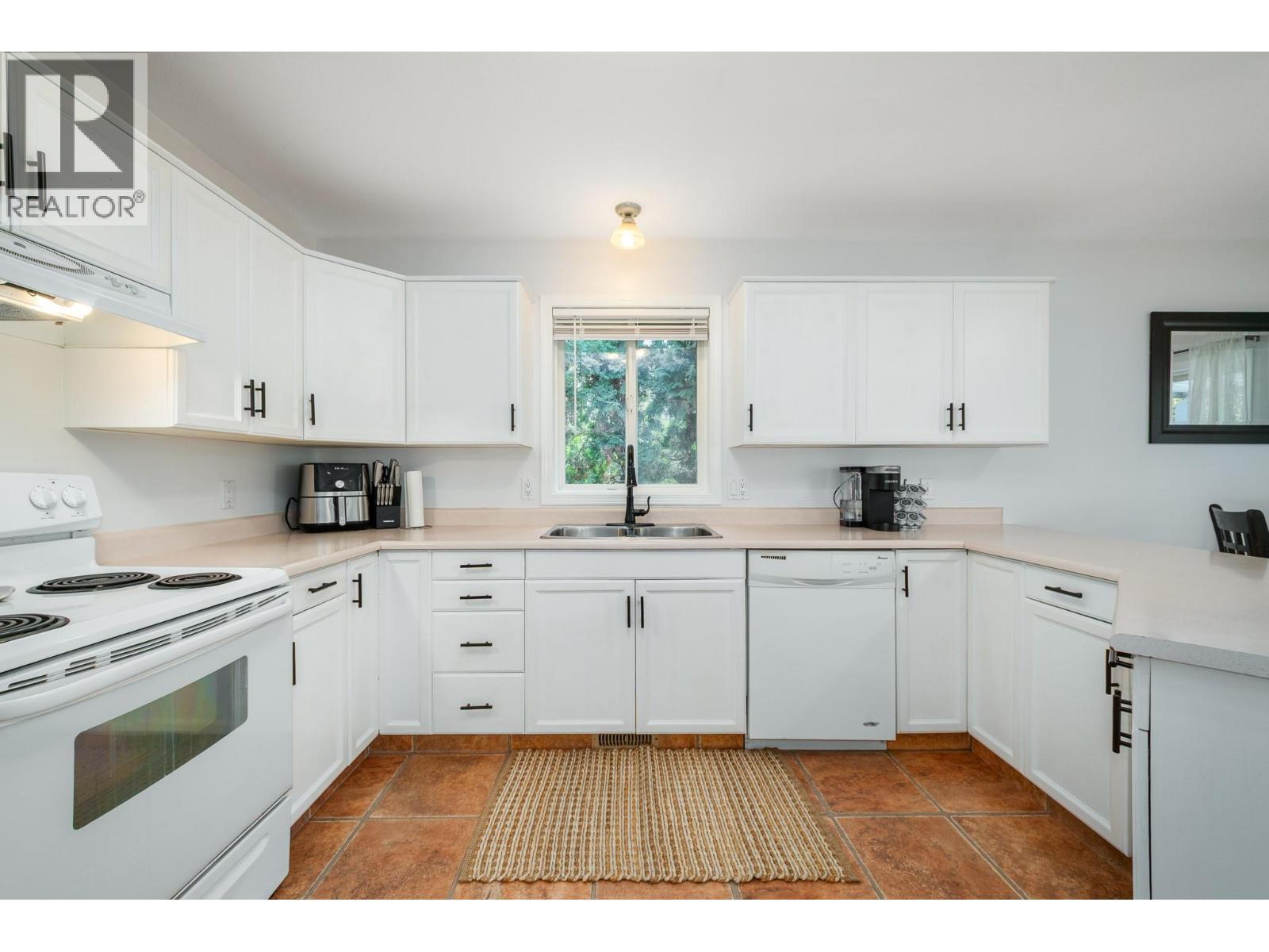 110 Wyndham Crescent, Kelowna, BC - Indoor Photo Showing Kitchen With Double Sink