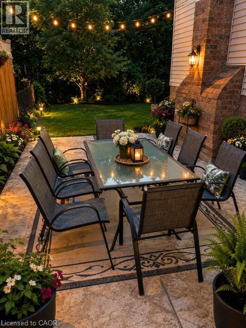 Expansive patio featuring stamped concrete, string lighting, and extensive perimeter landscaping - 143 Grenfell Place, London, ON - Outdoor