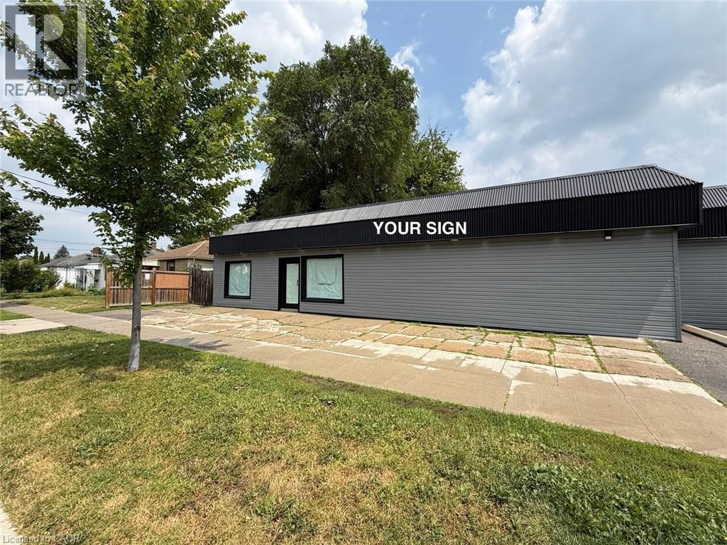 Commercial building with a flat, horizontal profile and a black corrugated metal roofline - 116 St Clair Avenue, Kitchener, ON