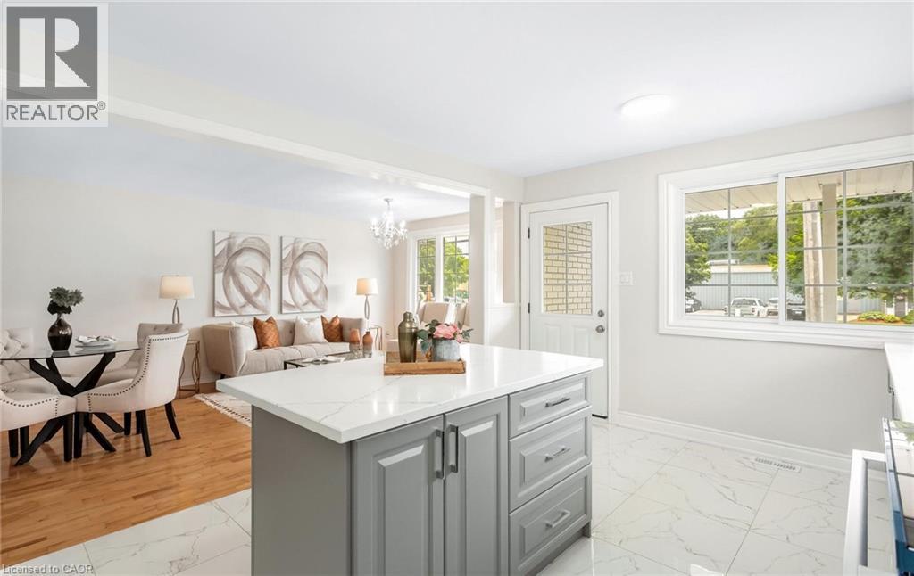 Kitchen island featuring a white countertop and gray cabinetry, set against white tile flooring - 176 Samuelson Street, Cambridge, ON - Indoor