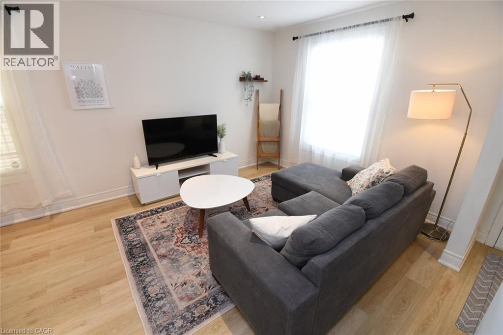 Living area featuring light wood-finish flooring and white baseboards - 106 Belview Avenue, Hamilton, ON - Indoor Photo Showing Living Room