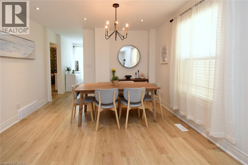 Dining area featuring wood-finish flooring, recessed lighting, and a modern chandelier - 106 Belview Avenue, Hamilton, ON - Indoor Photo Showing Dining Room