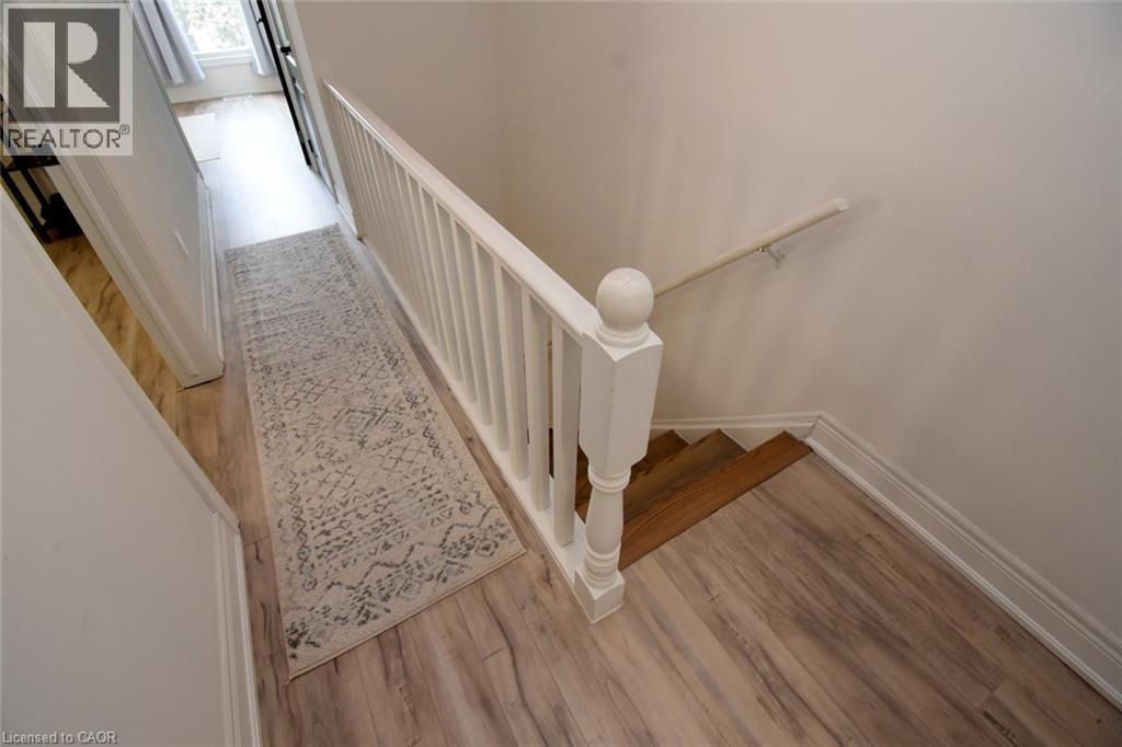 Hallway with wood-finish flooring and white baseboards - 106 Belview Avenue, Hamilton, ON - Indoor Photo Showing Other Room