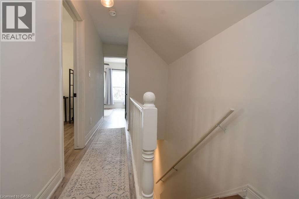 Hallway with light-toned walls and wood-finish flooring - 106 Belview Avenue, Hamilton, ON - Indoor Photo Showing Other Room