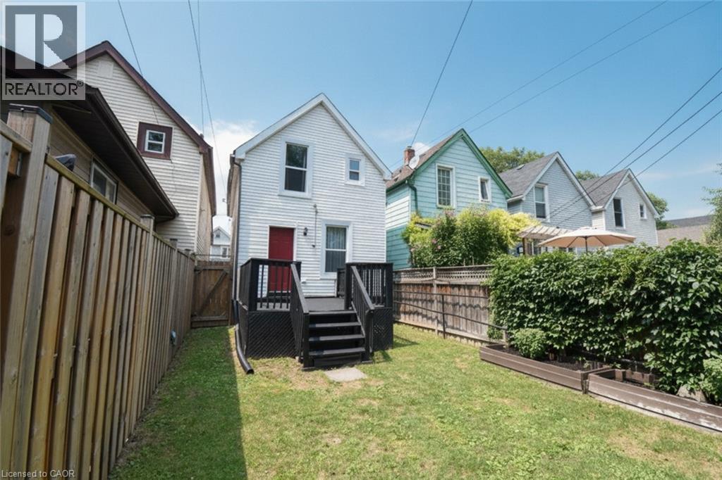 Expansive green lawn with a dark wood deck and privacy fencing - 106 Belview Avenue, Hamilton, ON - Outdoor