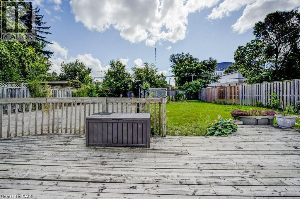 Wood deck with a slatted railing overlooking a grassy yard - 33 Sixth Avenue Unit# Upper, Kitchener, ON - Outdoor With Deck Patio Veranda
