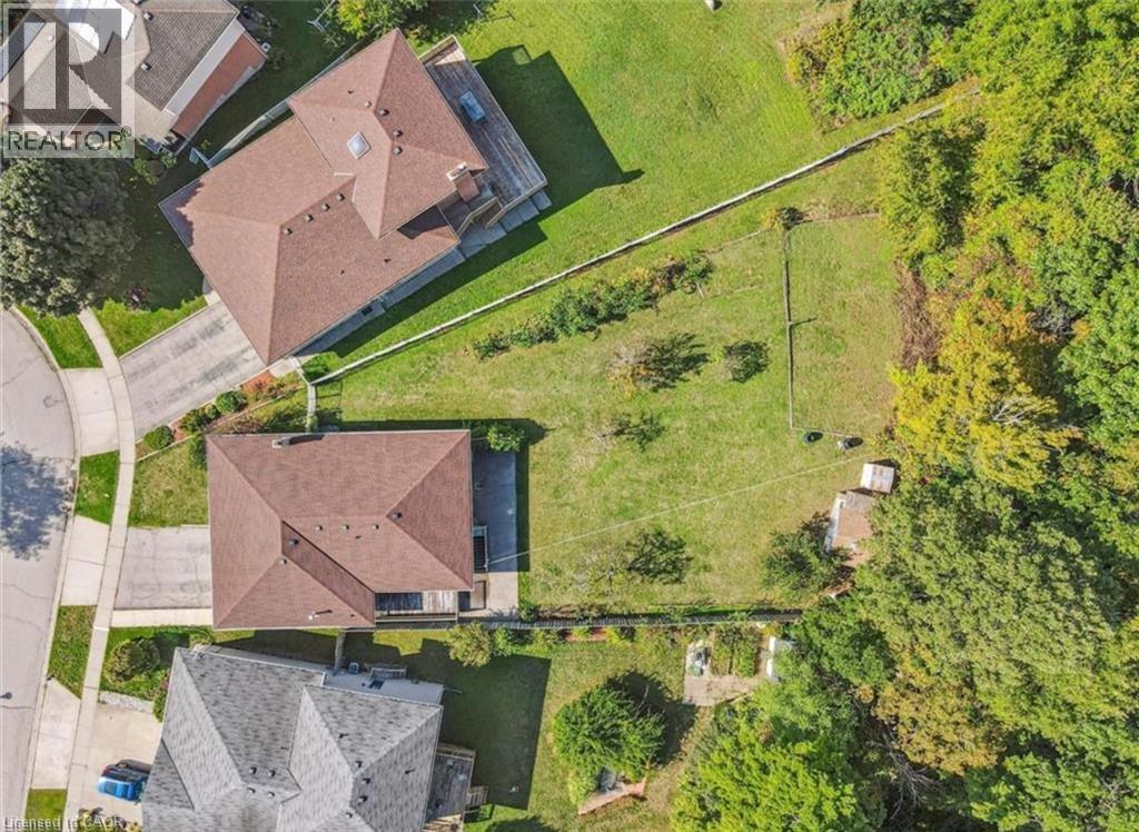 Expansive parcel featuring two distinct properties, extensive green space, and mature trees bordering the property line - 42 Azores Crescent, Cambridge, ON - Outdoor With View
