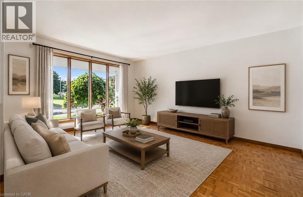 **Virtually Staged** Living area featuring expansive picture windows, wood-finish parquet flooring, and a neutral color palette - 42 Azores Crescent, Cambridge, ON - Indoor Photo Showing Living Room