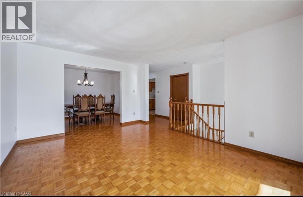 Bright interior space featuring parquet wood flooring and white walls - 42 Azores Crescent, Cambridge, ON - Indoor Photo Showing Other Room